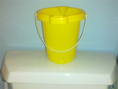 photo of a bucket on a toilet tank