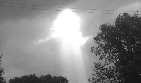 photo of a hole in clouds letting in the sun in Chicago