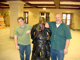 photo of Daniel Honigman, Bureaucratic Shuffle statue and Mike Maddaloni