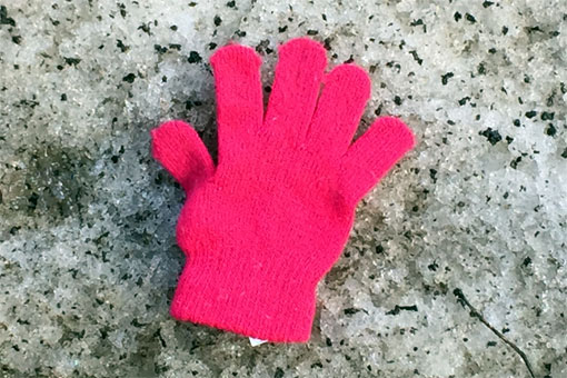 photo of kid’s glove in the snow