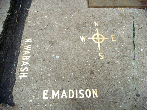 photo of compass in sidewalk at corner of Wabash and Madison, Chicago before construction