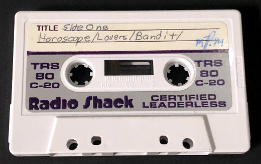 photo of an early computer cassette tape photo of an early computer cassette tape
