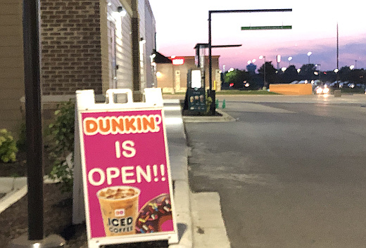 photo of Dunkin sign by closed Starbucks drive thru
