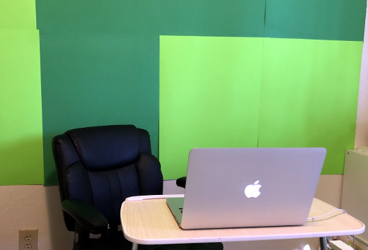 photo of green poster boards on the wall for green screen effect