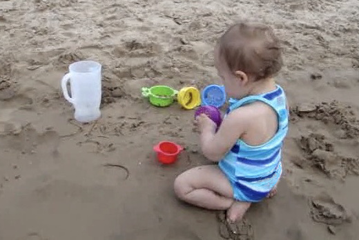 photo of a kid in a sandbox