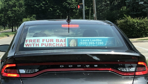 photo of realtor’s car with free pet sign