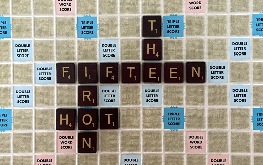 photo of Scrabble board with fifteen years of The Hot Iron